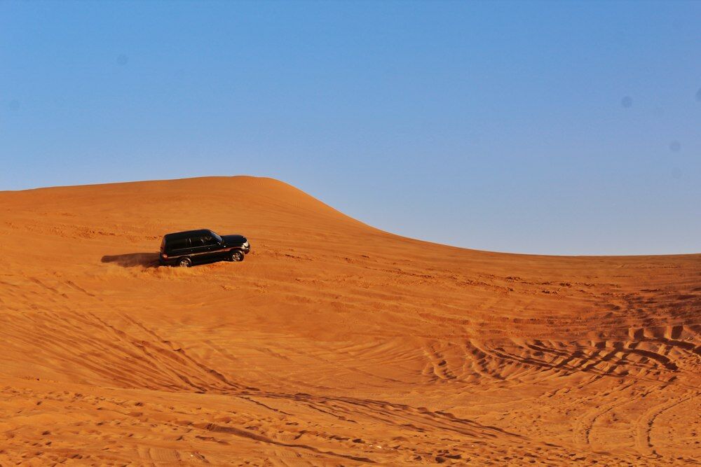 black suv on desert during daytime